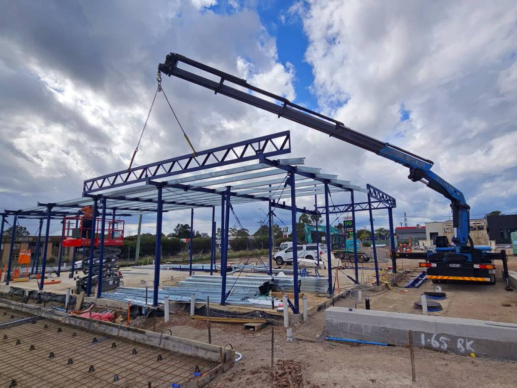 HIAB truck lifting construction beams in place